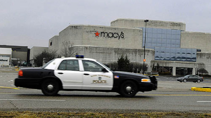 A Ross police crusier patrols the permitter of Ross Park Mall after an employee found a bomb threat written inside on a restroom wall.