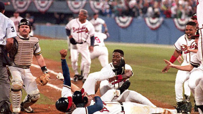 Sid Bream gets hugged by teammate David Justice on Oct. 14, 1992, after Bream scored the winning run in the bottom of the ninth, to clinch the National League Championship Series against the Pirates in Atlanta.