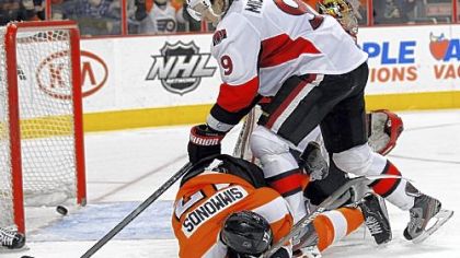 Philadelphia's Wayne Simmonds lies on the ice after a shot by teammate Brayden Schenn caromed off his face and into the net for a goal.