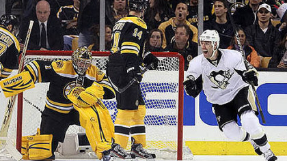 Pascal Dupuis, right, celebrates the first of Sidney Crosby's two goals against Bruins goalie Marty Turco Tuesday.