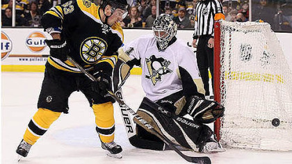 Brent Johnson makes a save against Boston's Brad Marchand -- one of his 26 in the Penguins' 5-3 victory.