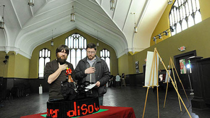 Matt Pritchard, left, and Matthew Case, both of South Homewood, look at the fourth station during the Open Door's seventh annual Stations of the Cross show in East Liberty on Friday.