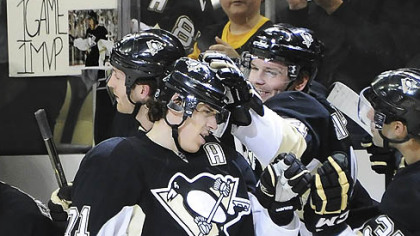 The Penguins' Evgeni Malkin is congratulated as he makes his way down the bench after scoring his 50th goal in tonight's win against the Flyers.