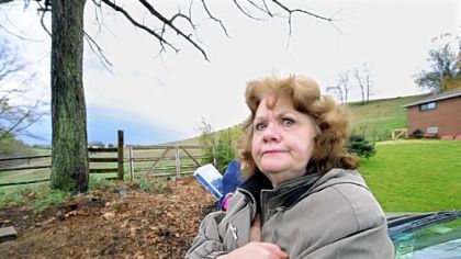 Caryn Falcone, who has lived on Pesavento Drive in Bridgeville for 40 years, opposes the opening of Main Street at its dead-end, shown behind her, to create an access road for the planned Bedner Farms housing development in neighboring Upper St. Clair.
