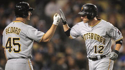 Pirates' Clint Barmes is congratulated by teammate Erik Bedard after hitting a solo home run.