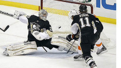 Philadelphia Flyers' Jakub Voracek scores in overtime past Penguins goalie Marc-Andre Fleury and Penguins' Jordan Staal  during Game 1 of the opening-round NHL hockey playoff series Wednesday, April 11, 2012. The Flyers won 4-3.