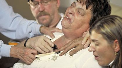 In 2009, while Deborah Houk, center, cried out mourning her daughter's death, relatives, including her daughter, Jennifer Kraner, right, tried to calm her.