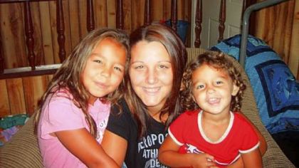 An undated photo of Kenzie Houk, center, with her daughters.