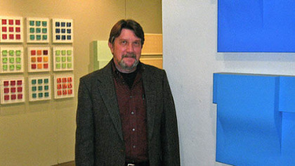 Artist David Ludwig in 2009 with his exhibition "Continuum" at Westmoreland County Community College. In the background are examples of his maquettes, an early stage of his working process.