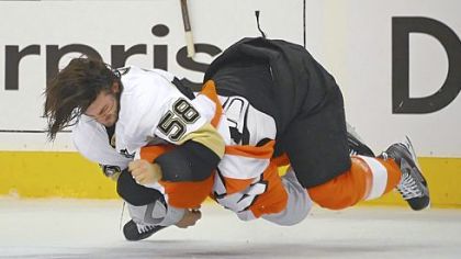 Kris Letang takes down the Flyers' Kimmo Timonen in what was a heated game Sunday in Philadelphia. The Penguins lost, 8-4, to go down, 3-0, in the series.