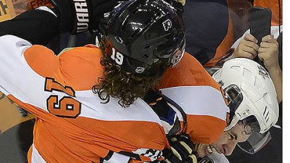 Sidney Crosby gets tied up with Scott Hartnell in the third period Sunday. After the game, Crosby said of the Flyers, "I don't like any guy on their team."
