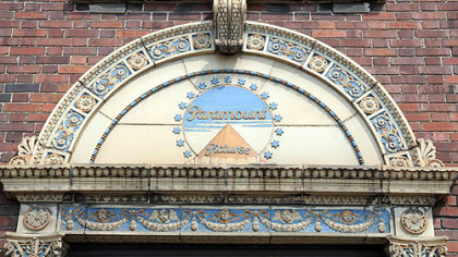 The ornate terra cotta logo of Paramount Films over the entrance of the Paramount building.