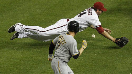 Arizona Diamondbacks' Joe Saunders tries to field a bunt by Pirates' Alex Presley during the fifth inning. Presley reached on an infield hit on the play.
