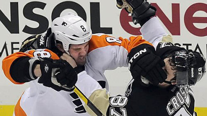 Flyers' Nicklas Grossman gets his glove in the face of Penguins' Sidney Crosby during game one of the Stanley Cup Playoffs at Consol Energy Center Wednesday night.