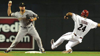 Pirates' Neil Walker throws the ball to first base as Chris Young  attempts to break up the double play.