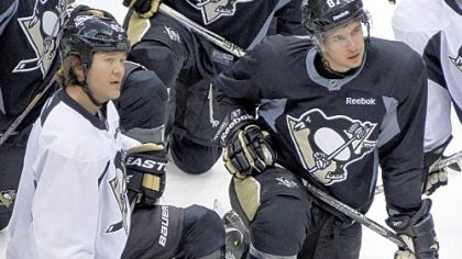 Sidney Crosby, right, and Arron Asham, left, listen during practice Tuesday before returning to Philadelphia for Game 4 of their series with the Flyers tonight. Asham practiced, but was later handed a one-game suspension along with Craig Adams and James Neal.