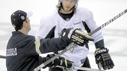 Kris Letang listens to assistant coach Todd Reirden at practice Tuesday.