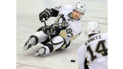 Sidney Crosby passes off to Chris Kunitz after being checked from behind by Philadelphia's Nick Grossmann Wednesday night. If Crosby was bothered by the Philadelphia media, it didn't show.