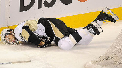 The Penguins' Kris Letang goes face-first into the boards during Wednesday night's game, resulting in a penalty for the Flyers' Nick Grossman.