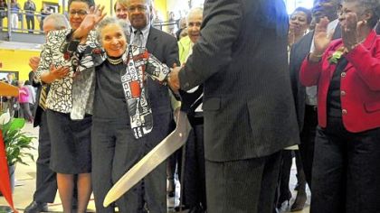 Thelma Lovette, 96, waves to the crowd after cutting the ribbon for the opening of the new Thelma Lovette YMCA in the Hill District.  Mrs. Lovette is a former resident and longtime activist in the Hill District. Her daughter, Thelma Lovette Morris, and son-in-law, Gregory Morris, are on each side of her.