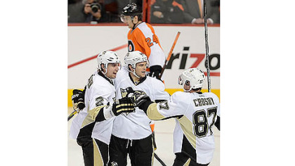 Sidney Crosby celebrates with teammates Matt Niskanen, far left, and Chris Kunitz, center.