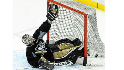 Penguins goalie Brent Johnson practices making glove saves during Thursday's practice.