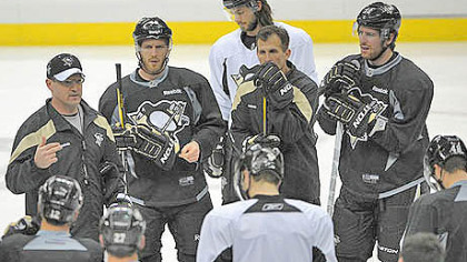 The Penguins gathered around head coach Dan Bylsma, left, as they practiced at the Consol Energy Center today before heading to Philadelphia for tomorrow's Game 6.