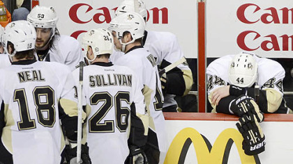 The Penguins' Brook Orpik hangs his head on the bench in the final seconds of Game 6 against the Flyers.