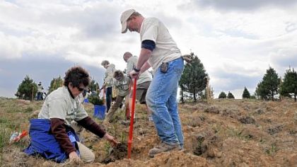 With assistance from Jeff Kozar of the Pennsylvania Bureau of Forestry, Debbie Borza of Annapolis, Md., plants a tree seedling Saturday at the Flight 93 National Memorial in Stonycreek, near Shanksville. Ms. Borza?s daughter, Deora Bodley, was aboard Flight 93, which crashed during the Sept. 11, 2001, terrorist attack.