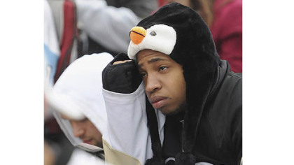 University of Pittsburgh student Manny Moorer of Charlotte, N.C. frowns at the Penguins' declining fortunes as fans gathered in the cold outside the Consol Energy Center to watch Game 6.