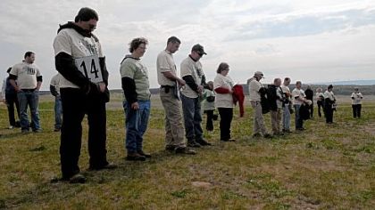 Volunteers observe a moment of silence in memory of those who died in the 9/11 terrorist attack before planting tree seedlings at the Flight 93 National Memorial in Stonycreek, Somerset County, on Saturday.