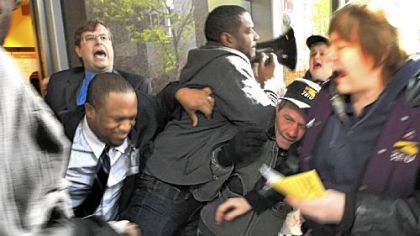 Protesters are pushed Wednesday while trying to enter the Au Bon Pain cafe at the EQT Plaza on Liberty Avenue, Downtown.