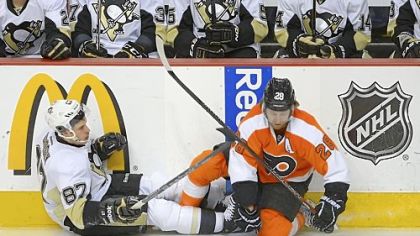 The Flyers' Claude Giroux, right, knocks Sidney Crosby off his feet seconds after the opening faceoff of Game 6 Sunday at Wells Fargo Center in Philadelphia. Giroux scored a goal moments later -- 32 seconds into the game -- and the Flyers won, 5-1, to eliminate the Penguins.