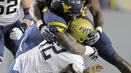 West Virginia's Bruce Irvin and Will Clarke sack Pitt's Tino Sunseri in the fourth quarter Friday.