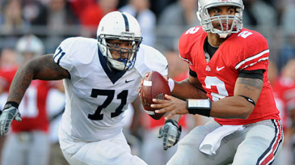 Ohio State quarterback Terrelle Pryor drops back to pass as Penn State's Devon Still closes in in the second quarter.