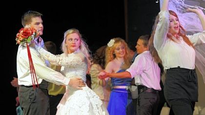 Tristan Brock, left, as Harold Fonda and Lindsey Howard, center, as Debbie Fonda look on as Lisa Lujetic, right, portraying Julia Sullivan sings "Someday" in Elizabeth Forward High School's production of "The Wedding Singer."