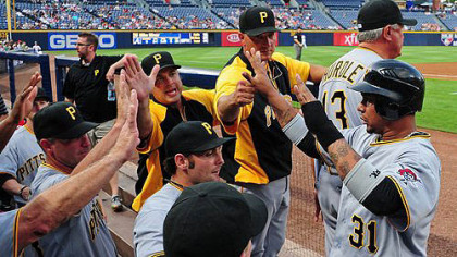 Jose Tabata #31 is congratulated by teammates after scoring against the Atlanta Braves.