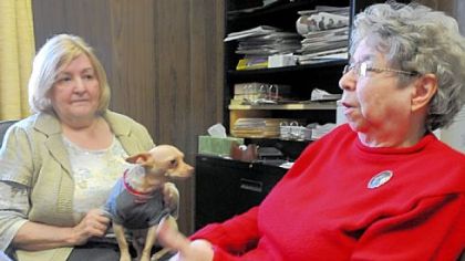 Charlene Word, left, and Georgia Boring, who are sisters, still run the Penn-Franklin News started by their father in 1947, sometimes with the help of Willie the chihuahua, Mrs. Word's office pet.