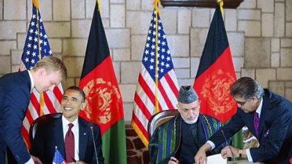 President Barack Obama and Afghan President Hamid Karzai, second from right, sign a strategic partnership agreement Tuesday at the presidential palace in Kabul.
