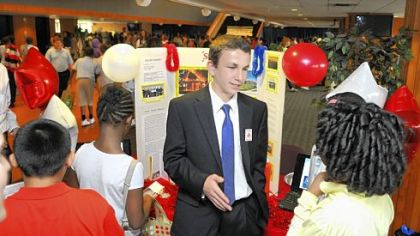 Eighth-grader Alex Novelli, from Our Lady of Grace School in Scott, represents a State Farm agent while talking with fifth-graders during the Pittsburgh's Future ... Now! Job Fair sponsored by Junior Achievement at Duquesne University.