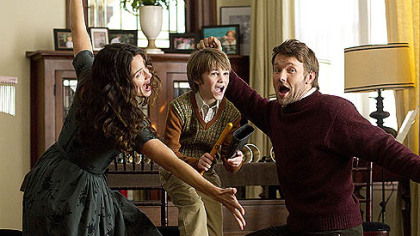 Cindy (Jennifer Garner, left), Timothy (CJ Adams, center) and Jim (Joel Edgerton, right) Green give an impromptu performance at a family gathering in the movie "The Odd Life of Timothy Green," which opens Aug. 15.