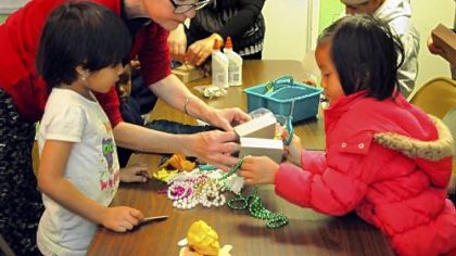 Joann Kielar, artist in residence, teaches children and their parents how to make puppets at South Hills Interfaith Ministries family center in the Whitehall Place apartments in Whitehall.