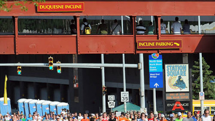 Runners stream along West Carson Street past the Duquesne Incline.