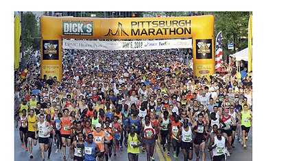 Elite runners sprint from the start line along Liberty Ave. as the Pittsburgh Marathon begins.