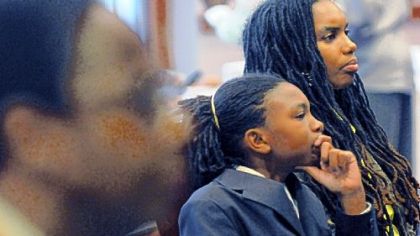 Troy Thompson, 12, from Regent Square and his mother, Khaleelah Glover, at the Gateway Medical Society medical mentoring program. "As he's been given more responsibility, he's gotten more confident around his peers," says Ms. Glover.