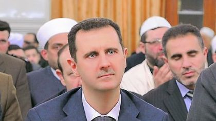 A photo released by the Syrian Arab News Agency shows President Bashar Assad attending a prayer service Sunday marking the birth of Islam's Prophet Muhammad at a mosque in Damascus, Syria.