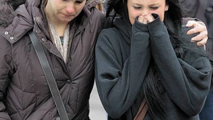 A distraught Ava Polaski, a sophomore, leaves school grounds Monday with her mother, Misty Polaski, following the school shooting in Chardon, Ohio.