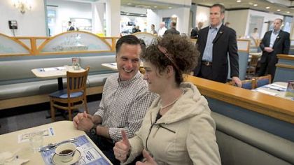 Former Massachusetts Gov. Mitt Romney gets two thumbs up from a supporter in Fond du Lac, Wis., as Secret Service agents look on Friday.
