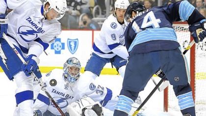 Lightning goalie Mathieu Garon makes a save against the Penguins' Chris Kunitz Sunday at Consol Energy Center.