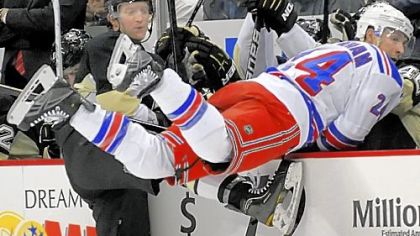 Paul Martin checks New York's Ryan Callahan into the Penguins bench Tuesday night at Consol Energy Center.